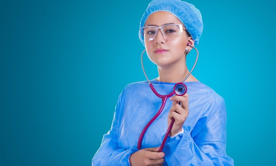 nurse dressed in blue scrubs with stethoscope