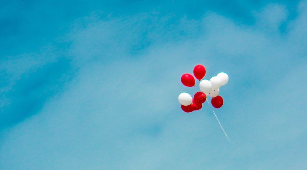 red and white balloons in the sky