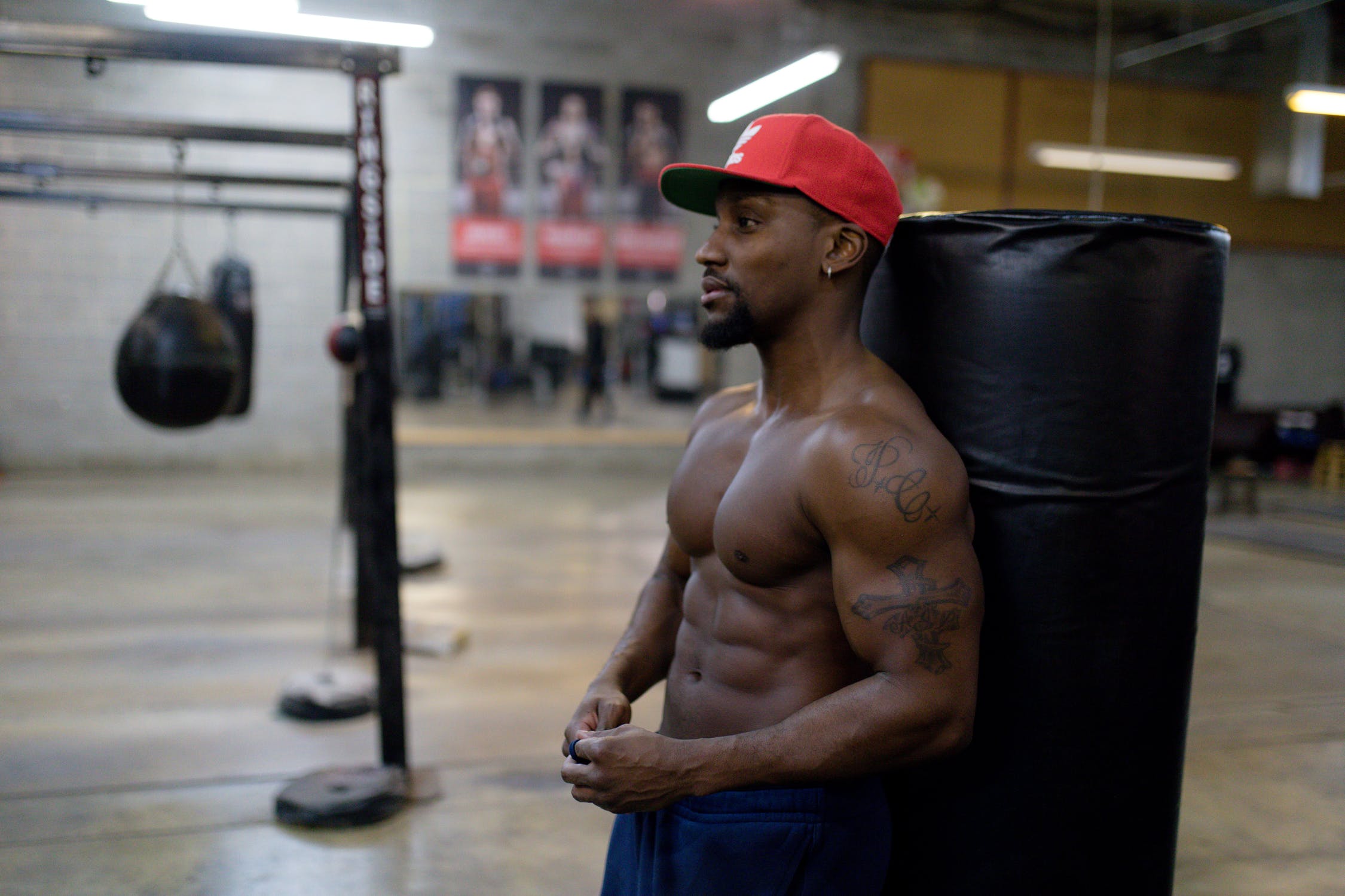 man leaning on punching bag