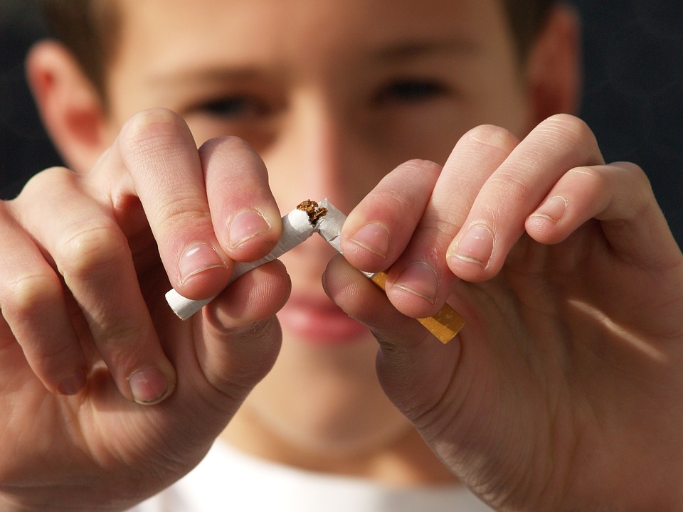 child breaking a cigarette in half 